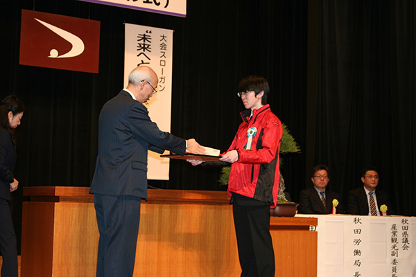 「秋田県職業能力開発協会」で表彰状を受け取る伊藤の写真